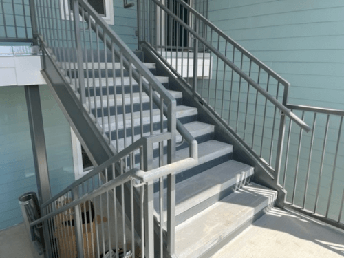 Outside stairs at an apartment complex, view from the second tier