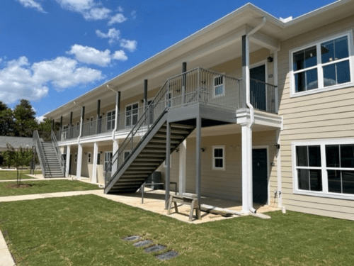 Outside view of an apartment complex and the stairs that lead to the second floor.